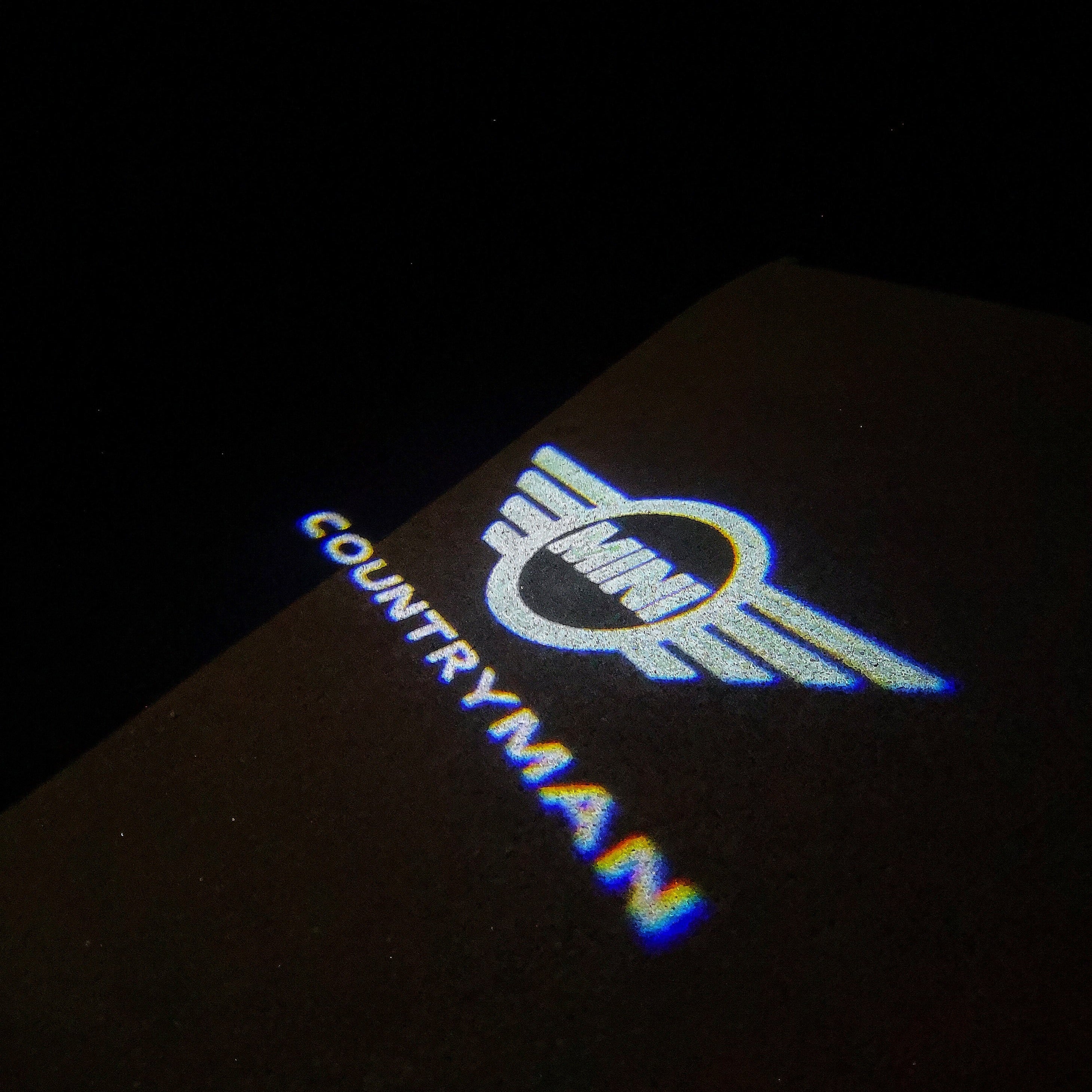 LUCES DE PROYECTOR CON LOGO MINI COUNTRYMAN Nr.131 (cantidad 1 = 2 Película de Logo / 2 luces de puerta)