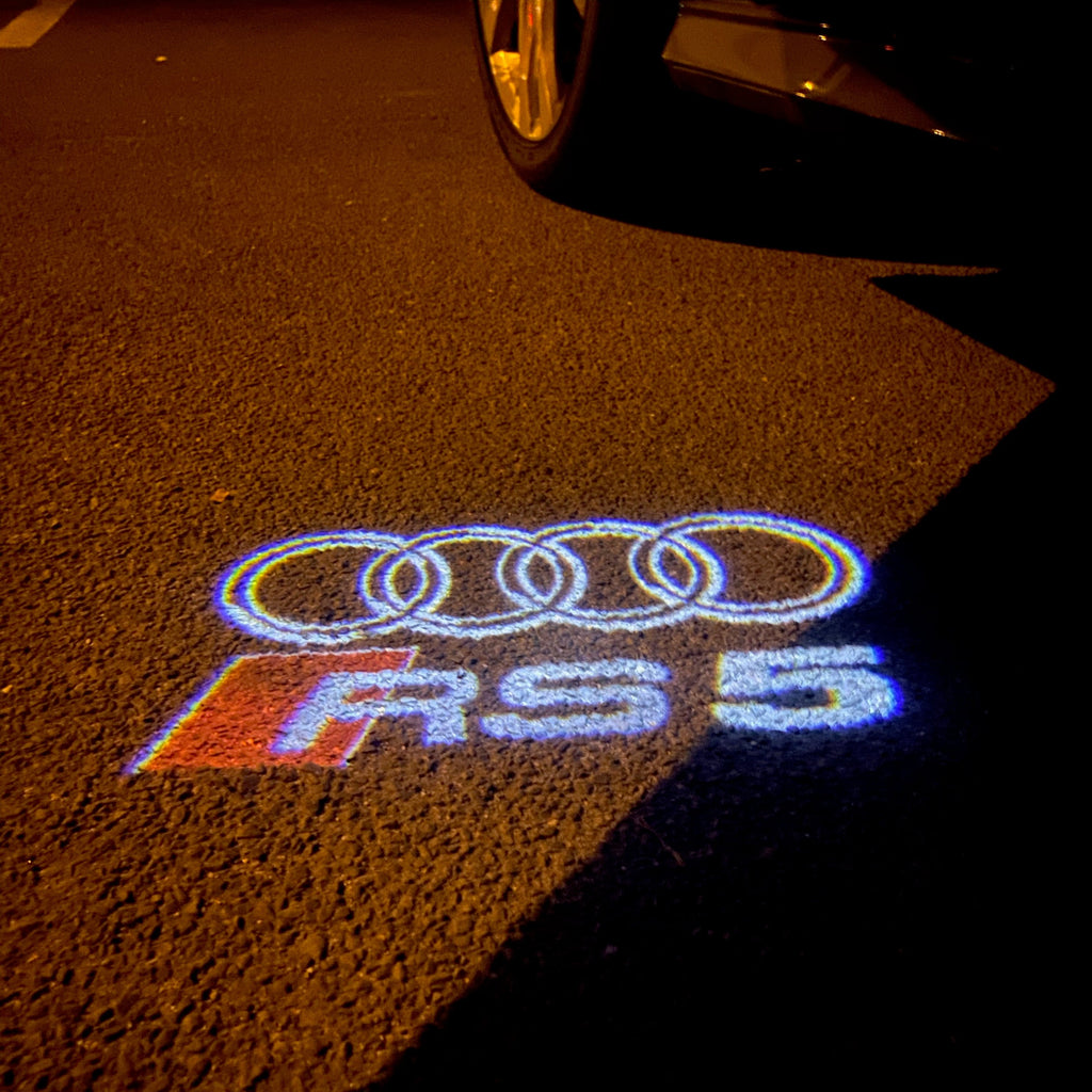 AUDI LOGO PROJECTOT LIGHTS Nr.136 (الكمية 1 = 2 Logo Films /2 أضواء الباب)